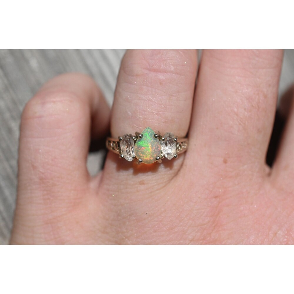 Brilliant opal ring, teardrop or pear shaped center stone with raw clear oval si